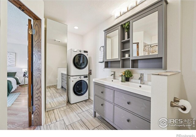 951 Vetch Cir, Lafayette, CO 80026 - washroom featuring estacked washer and dryer and baseboards