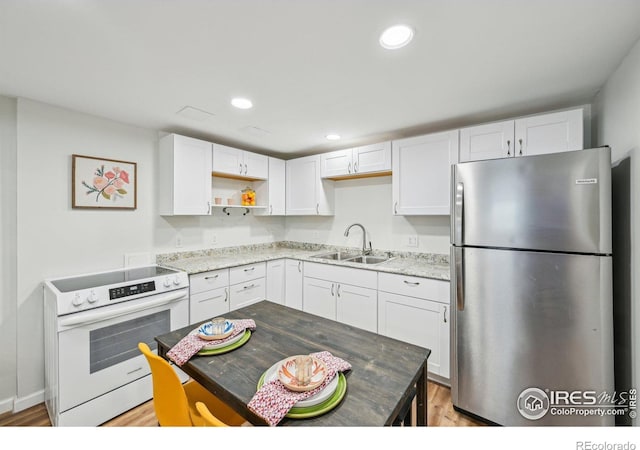 951 Vetch Cir, Lafayette, CO 80026 - kitchen featuring freestanding refrigerator, electric range, open shelves, white cabinetry, and recessed lighting