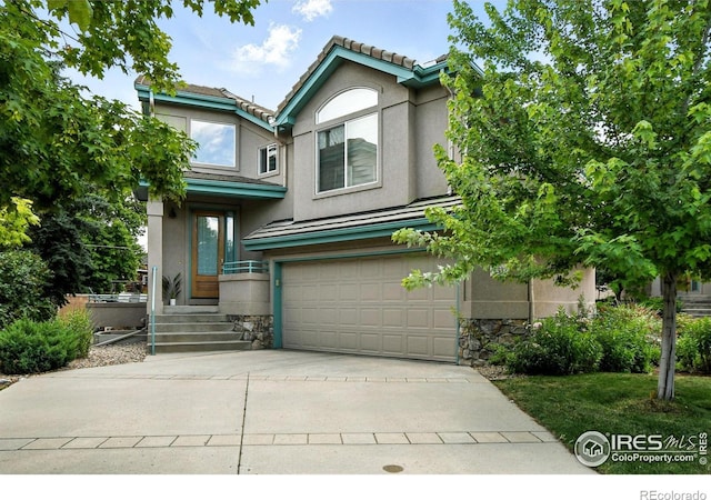4332 Clay Commons Ct, Boulder, CO 80303 - view of front facade with a garage, stucco siding, stone siding, driveway, and a tiled roof
