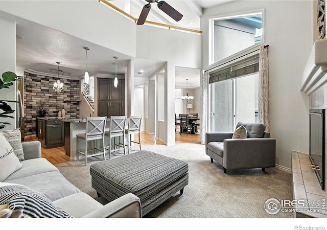 4332 Clay Commons Ct, Boulder, CO 80303 - living room with a ceiling fan, a towering ceiling, a chandelier, and light carpet