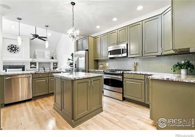 4332 Clay Commons Ct, Boulder, CO 80303 - kitchen featuring appliances with stainless steel finishes, decorative backsplash, light wood-style floors, lofted ceiling, and recessed lighting