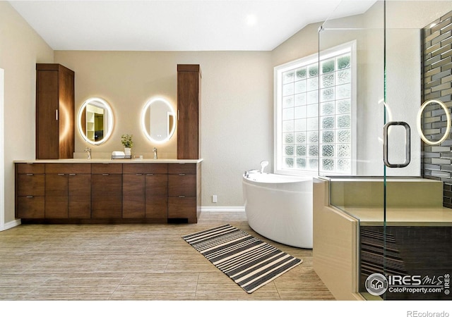 4332 Clay Commons Ct, Boulder, CO 80303 - full bath featuring double vanity, a freestanding tub, vaulted ceiling, and a shower with door