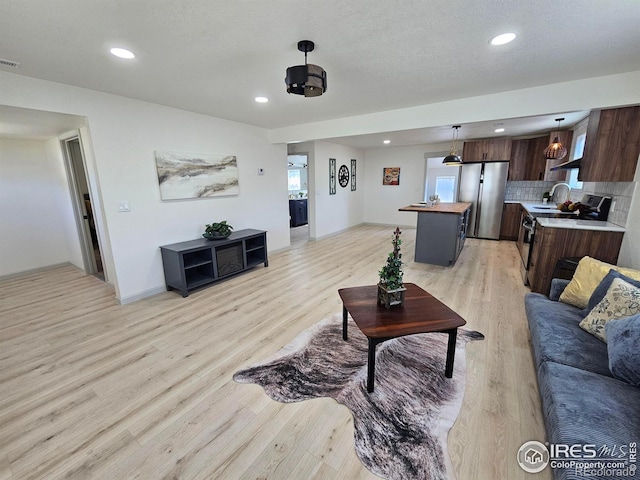 202 N 7th Ave, Sterling, CO 80751 - living room with light wood-style floors and recessed lighting