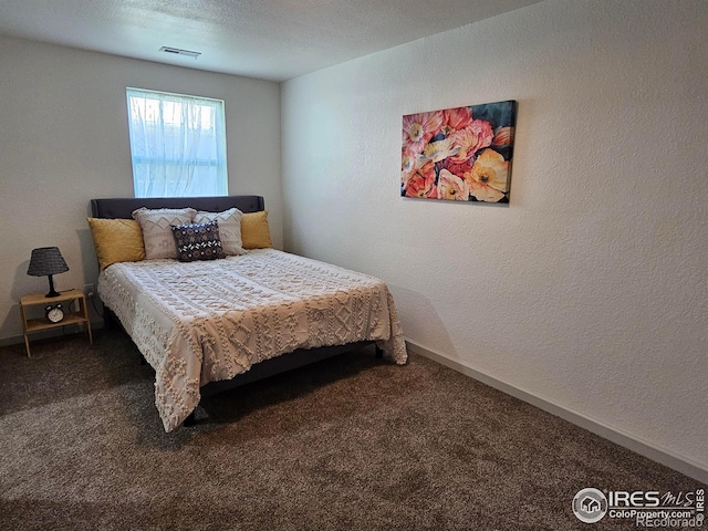 202 N 7th Ave, Sterling, CO 80751 - carpeted bedroom with a textured wall and baseboards