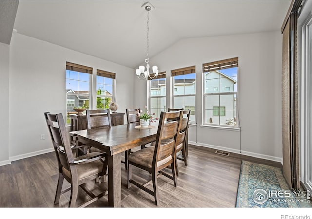12648 Canoe St, Firestone, CO 80504 - dining space with wood finished floors, vaulted ceiling, and a chandelier