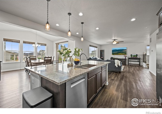 12648 Canoe St, Firestone, CO 80504 - kitchen featuring stainless steel dishwasher, ceiling fan, dark wood-style flooring, open floor plan, and recessed lighting