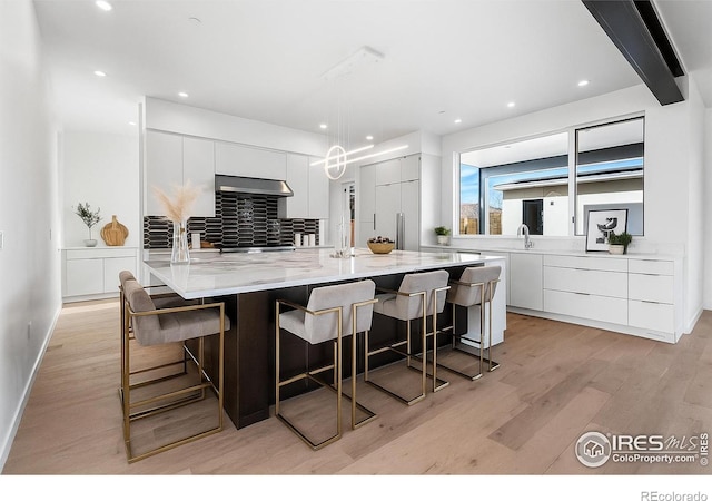 2145 Vine Ave, Boulder, CO 80304 - kitchen featuring modern cabinets, light wood-style floors, white cabinetry, ventilation hood, and recessed lighting