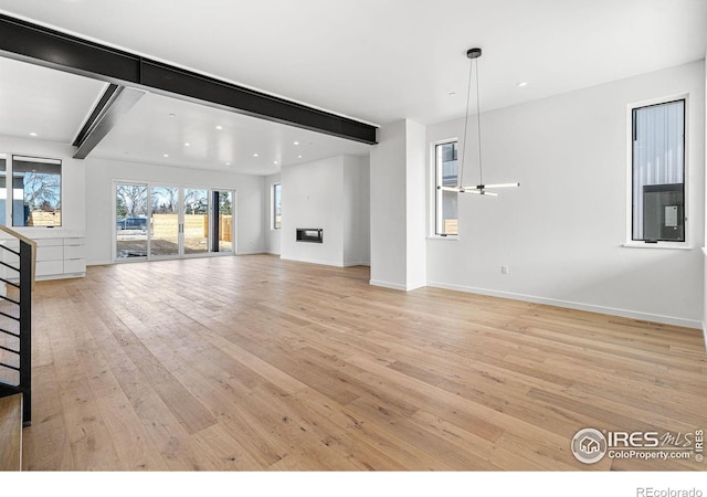 2145 Vine Ave, Boulder, CO 80304 - unfurnished living room with light wood-style floors, beam ceiling, and recessed lighting