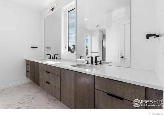 2145 Vine Ave, Boulder, CO 80304 - bathroom featuring double vanity and marble look tiles