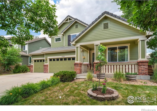 17132 E 104th Way, Commerce City, CO 80022 - craftsman house featuring covered porch, brick siding, an attached garage, driveway, and a front yard