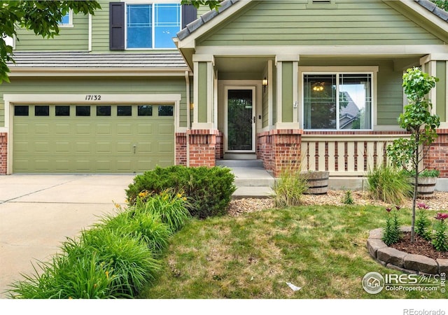 17132 E 104th Way, Commerce City, CO 80022 - view of front of house with brick siding, a garage, driveway, and covered porch