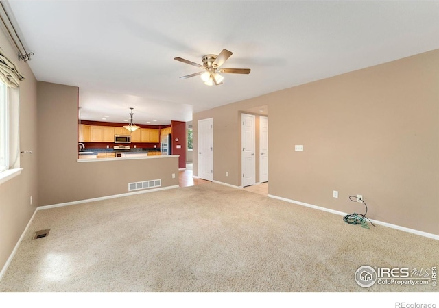 17132 E 104th Way, Commerce City, CO 80022 - unfurnished living room with a ceiling fan and light colored carpet
