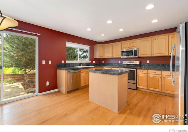 17132 E 104th Way, Commerce City, CO 80022 - kitchen featuring appliances with stainless steel finishes, light wood-style floors, light brown cabinetry, recessed lighting, and a center island