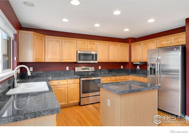 17132 E 104th Way, Commerce City, CO 80022 - kitchen with stainless steel appliances, light brown cabinets, light wood-style flooring, a kitchen island, and recessed lighting