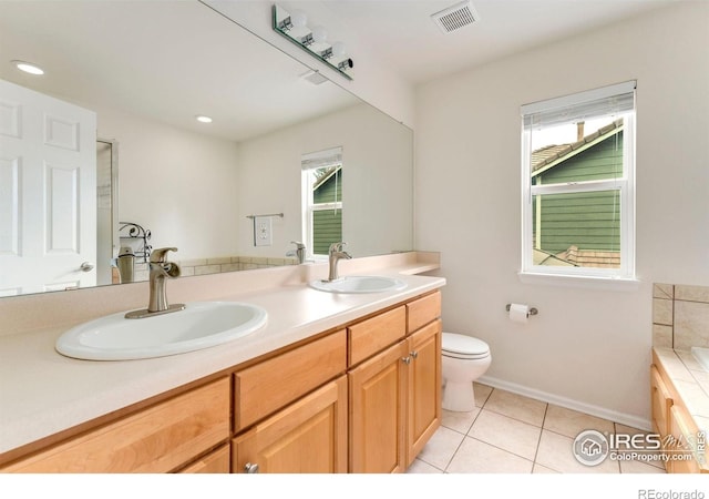 17132 E 104th Way, Commerce City, CO 80022 - bathroom with double vanity, tile patterned floors, a tub to relax in, and recessed lighting