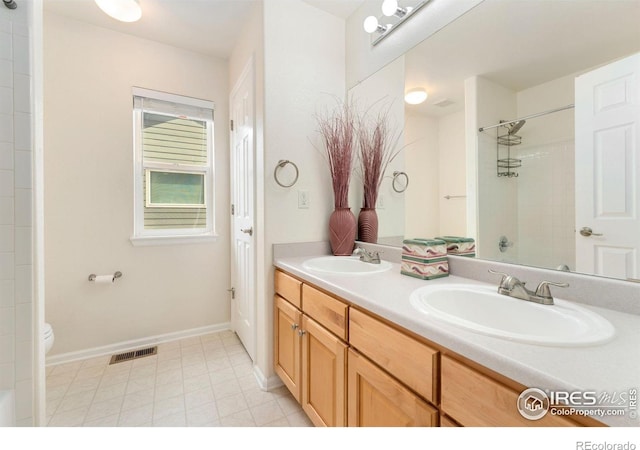 17132 E 104th Way, Commerce City, CO 80022 - full bathroom with double vanity and a tile shower