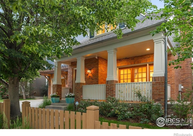 901 Terrace Cir S, Boulder, CO 80304 - view of front of house with brick siding, a porch, and a shingled roof