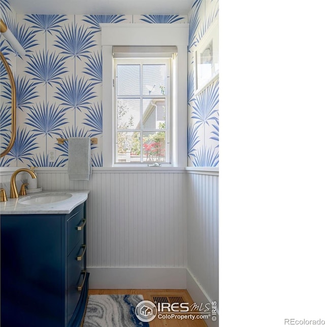 901 Terrace Cir S, Boulder, CO 80304 - detailed view of wallpapered walls, wainscoting, vanity, and wood finished floors
