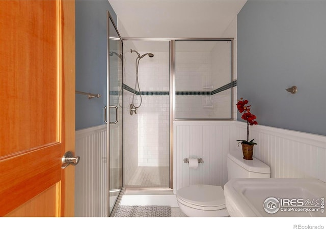 901 Terrace Cir S, Boulder, CO 80304 - full bathroom featuring wainscoting, a shower stall, and tile patterned floors