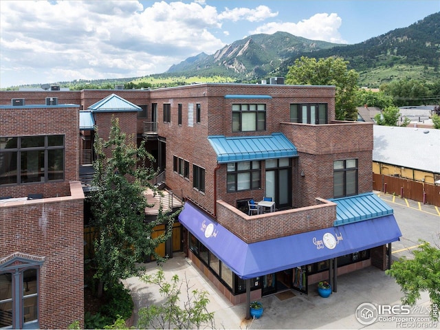 820 Pearl St, Boulder, CO 80302 - back of property with a mountain view, brick siding, and a standing seam roof