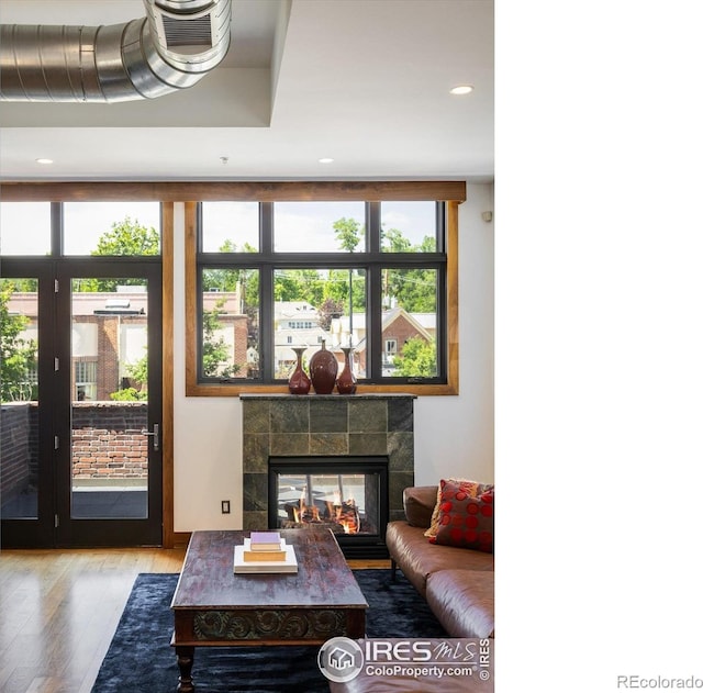 820 Pearl St, Boulder, CO 80302 - living area featuring plenty of natural light, wood finished floors, a tiled fireplace, and recessed lighting