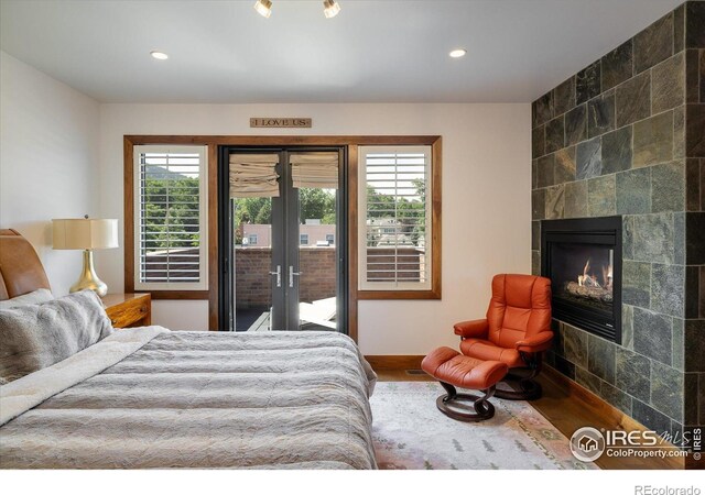 820 Pearl St, Boulder, CO 80302 - bedroom featuring access to outside, multiple windows, wood finished floors, a tiled fireplace, and recessed lighting