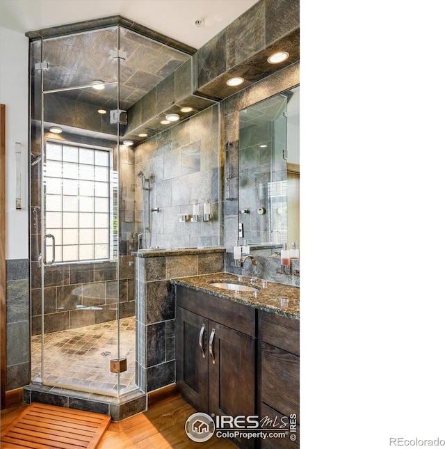 820 Pearl St, Boulder, CO 80302 - full bathroom featuring vanity, a shower stall, and wood finished floors