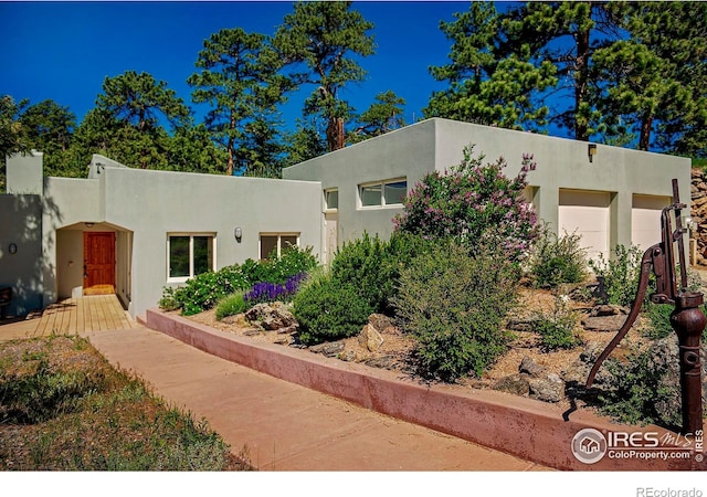 3884 Douglas Mountain Dr, Golden, CO 80403 - adobe home with stucco siding