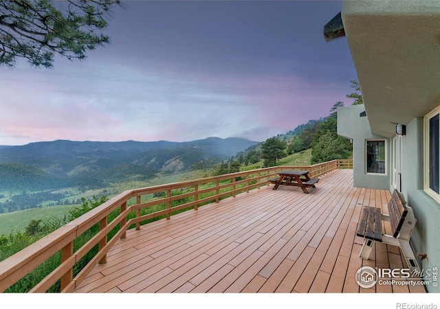 3884 Douglas Mountain Dr, Golden, CO 80403 - deck at dusk featuring a mountain view