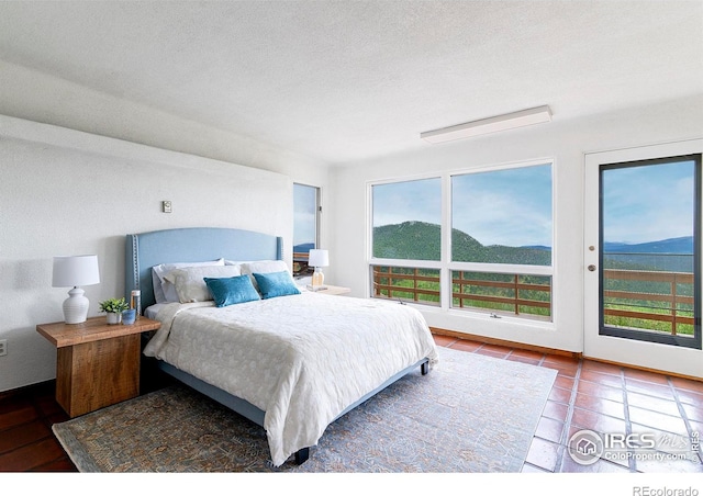 3884 Douglas Mountain Dr, Golden, CO 80403 - bedroom featuring access to outside and tile patterned flooring