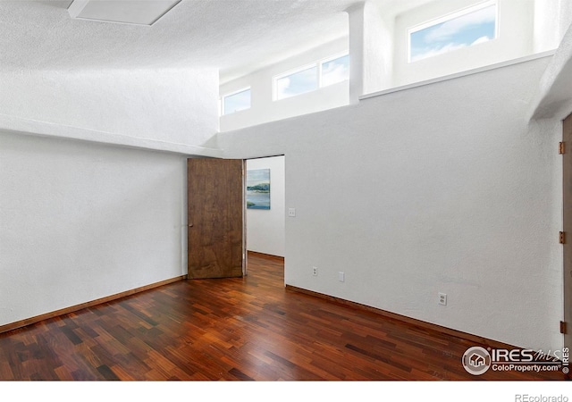3884 Douglas Mountain Dr, Golden, CO 80403 - unfurnished room featuring wood finished floors and a towering ceiling