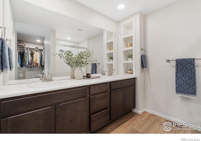 5199 Beckworth St, Timnath, CO 80547 - full bath featuring wood finished floors, double vanity, a spacious closet, recessed lighting, and a shower