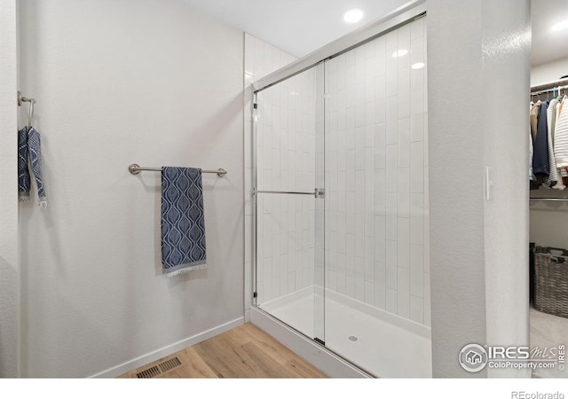 5199 Beckworth St, Timnath, CO 80547 - bathroom with wood finished floors, a shower stall, a spacious closet, and recessed lighting