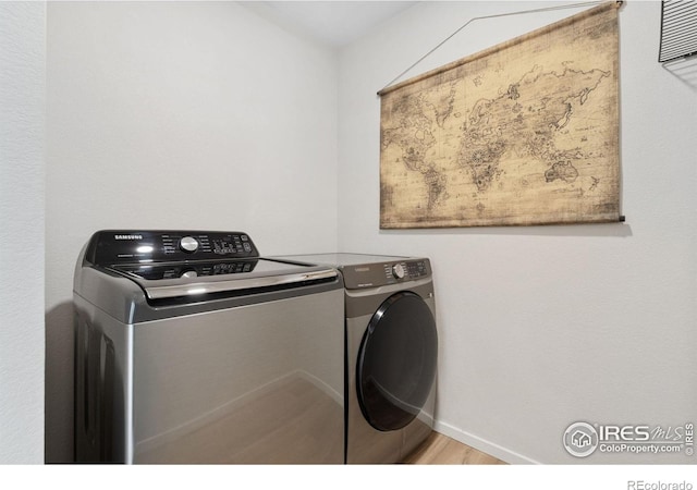 5199 Beckworth St, Timnath, CO 80547 - laundry room with washer and dryer and wood finished floors