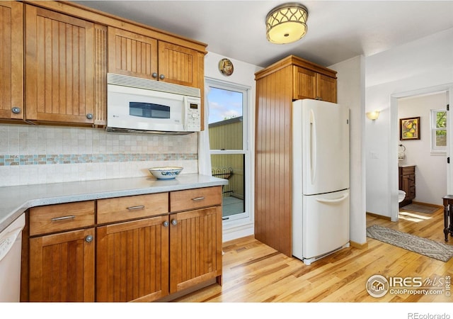 1620 Bradley Ct, Boulder, CO 80305 - kitchen with white appliances, light wood finished floors, and decorative backsplash