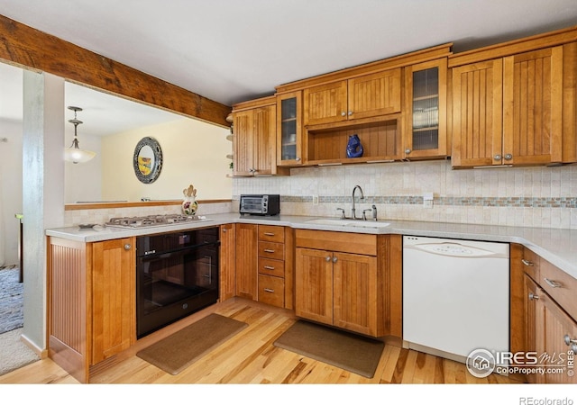 1620 Bradley Ct, Boulder, CO 80305 - kitchen featuring black oven, dishwasher, stainless steel gas cooktop, and light wood-style floors