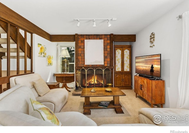 1620 Bradley Ct, Boulder, CO 80305 - carpeted living area with a brick fireplace, track lighting, and stairway