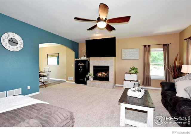 405 Ridgeview Ct, Johnstown, CO 80534 - living area featuring arched walkways, plenty of natural light, ceiling fan, and carpet