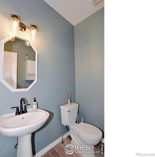 405 Ridgeview Ct, Johnstown, CO 80534 - half bathroom featuring toilet and wood finished floors