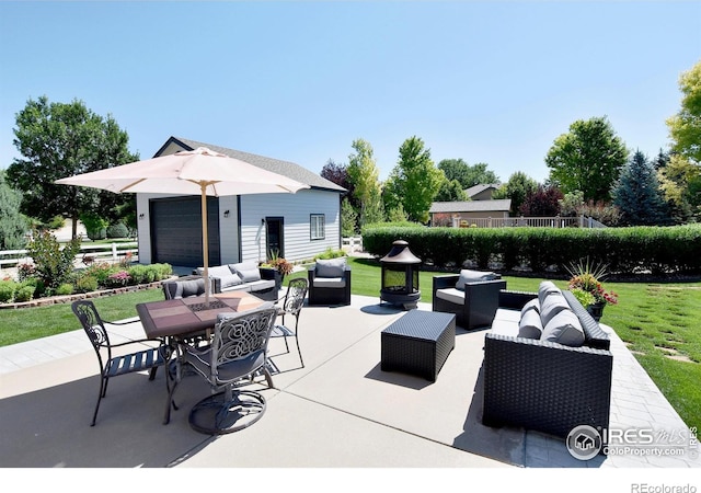 405 Ridgeview Ct, Johnstown, CO 80534 - view of patio / terrace with outdoor lounge area, an outbuilding, and a garage