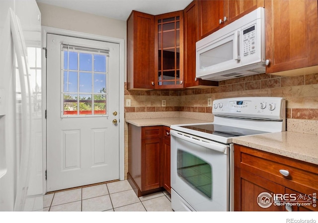 253 W Cedar Way, Louisville, CO 80027 - kitchen featuring white appliances, light tile patterned flooring, glass insert cabinets, and tasteful backsplash