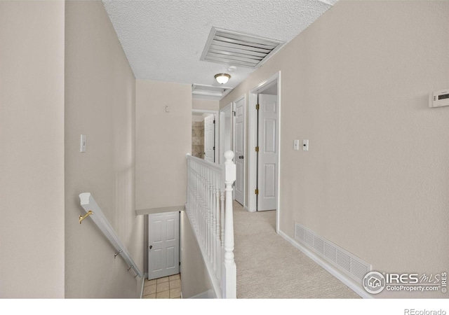 253 W Cedar Way, Louisville, CO 80027 - hallway with an upstairs landing, a textured ceiling, and carpet