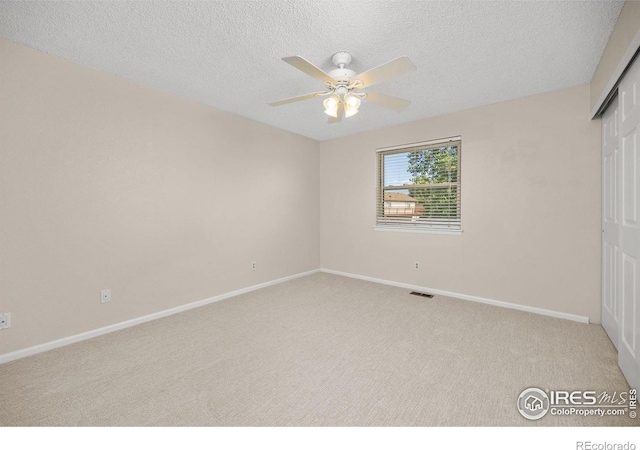 253 W Cedar Way, Louisville, CO 80027 - unfurnished bedroom featuring carpet floors, a closet, a textured ceiling, and ceiling fan