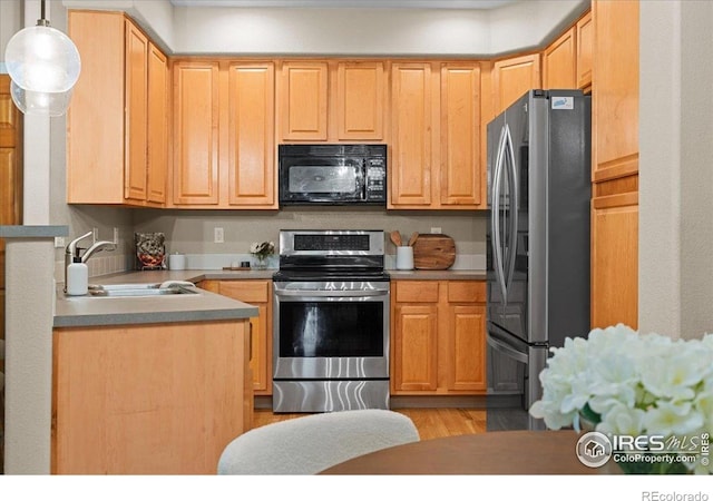 5220 Boardwalk Dr Unit 22, Fort Collins, CO 80525 - kitchen featuring appliances with stainless steel finishes, decorative light fixtures, light wood-style floors, and light brown cabinetry