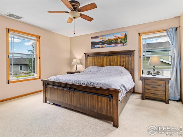 1695 Gray Hawk Ct, Estes Park, CO 80517 - bedroom featuring light colored carpet, multiple windows, a ceiling fan, and access to exterior