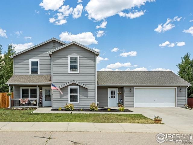 1695 Gray Hawk Ct, Estes Park, CO 80517 - traditional home featuring a garage, concrete driveway, a porch, and roof with shingles