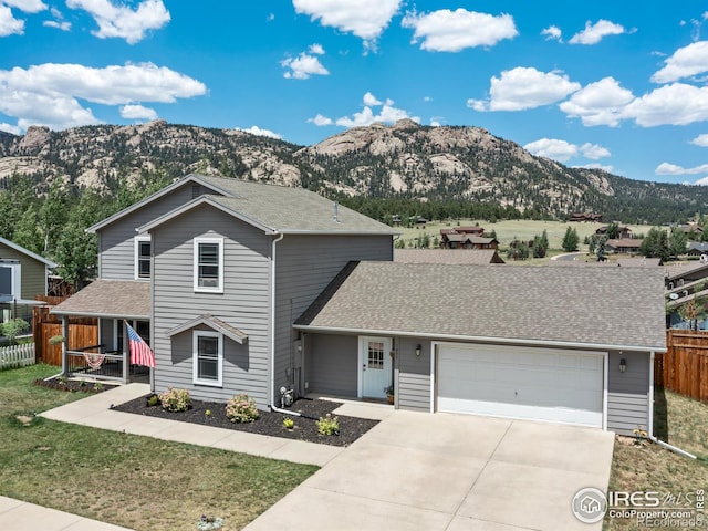 1695 Gray Hawk Ct, Estes Park, CO 80517 - traditional home with a mountain view, concrete driveway, a garage, and roof with shingles