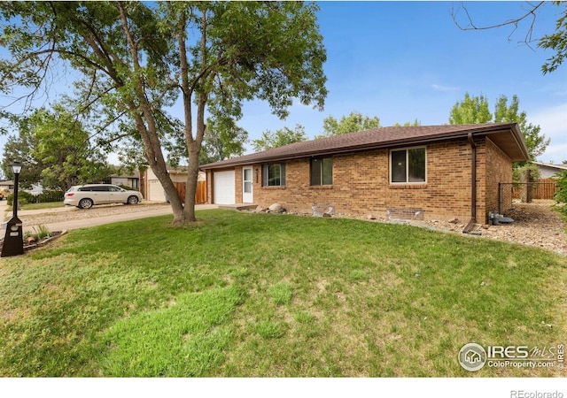 530 Mount Evans St, Longmont, CO 80504 - ranch-style home featuring an attached garage, brick siding, and concrete driveway