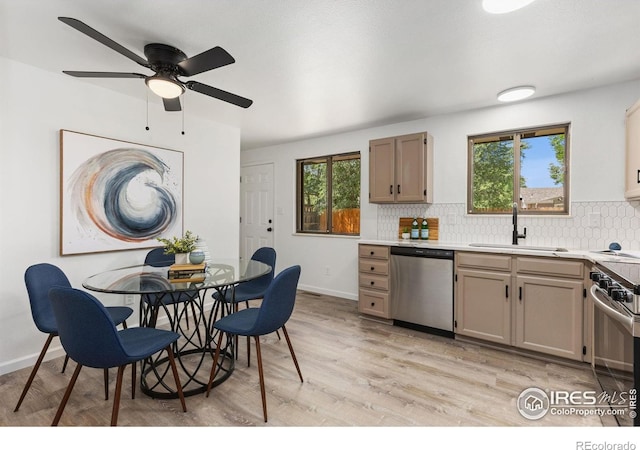 530 Mount Evans St, Longmont, CO 80504 - kitchen featuring appliances with stainless steel finishes, healthy amount of natural light, backsplash, and light countertops