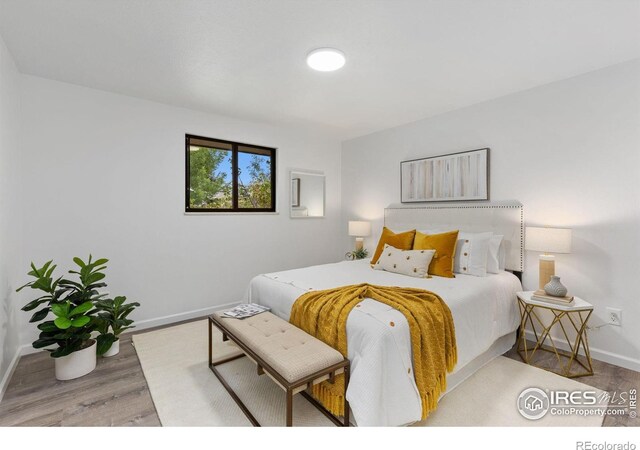 530 Mount Evans St, Longmont, CO 80504 - bedroom with baseboards and wood finished floors